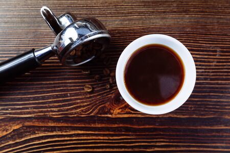 A cup of black coffee and filter holder of espresso.の写真素材
