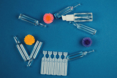 Abstract model of coronavirus, ampoule with medicine and bottle with antibacterial gel for hands on...