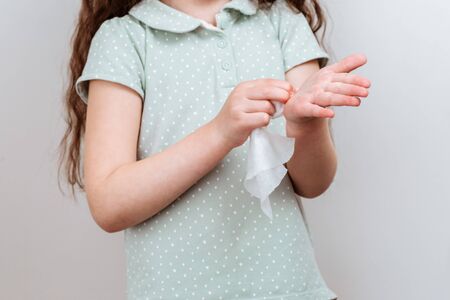 The child wipes her hands wet antibacterial wipe. Stop virus.の写真素材
