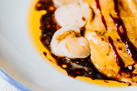 Scallop ceviche and foie gras with hazelnut, ready to serve.の写真素材