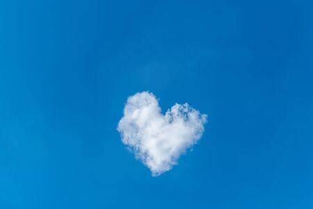 Romantic cloud in the shape of a heart on a blue sky. Love concept.の写真素材