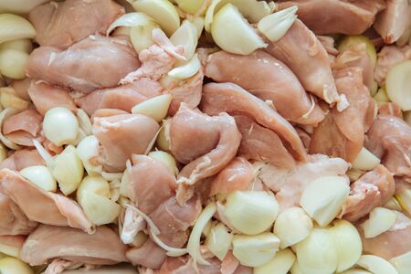 Raw meat cut into pieces and onions. Close up.の写真素材