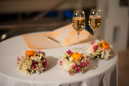 Beautiful festive table setting. The table and room are decorated with flower arrangements.の写真素材
