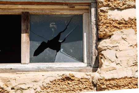 Broken glass in a building window. Housing problems.