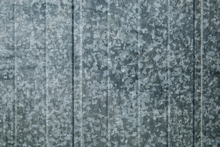 Tin fence with a beautiful textured pattern. Graffiti Place. Modern fence with vertical stripes.