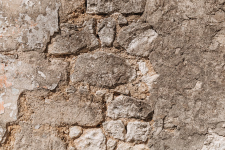 An old wall that is collapsing. Bricks visible. Textured.
