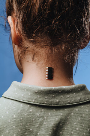 Implantation of chip under the human skin. Microchip is connected to the girl body. Concept of...