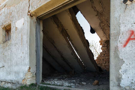 The wall with the doorway in the ruins of the collapse of the devastation. Danger of collapse.の写真素材