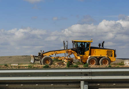 Grader yellow, industrial machine for the construction of new roads.の写真素材
