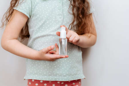 Antibacterial hand remedy in children's hands.Coronavirus epidemic warningの写真素材