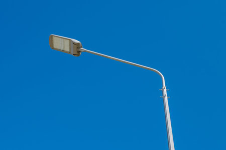 Street lamp against a clear blue sky. .A modern street LED lighting pole. Copy space.