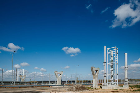 Supports are prepared for the construction of a pedestrian crossing over the road against the sky....