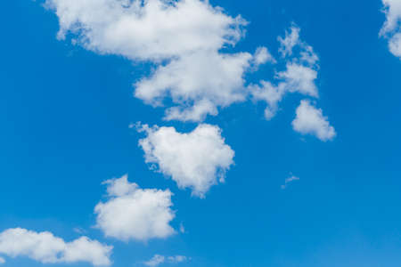 Blue clear sky with white fluffy clouds. Natural background.の写真素材