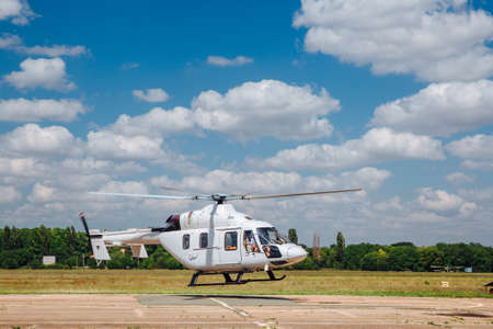 A white helicopter takes off from the runway.の写真素材