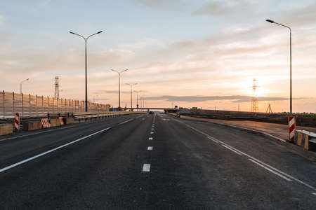 Newly built road with soundproof panels against the background of sunset.の写真素材