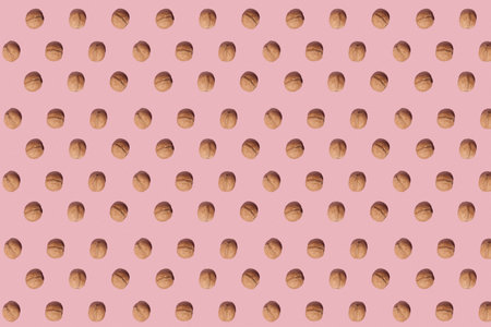 Inshell walnuts on a pink background. Organic products and healthy lifestyle. Flat lay. Pattern
