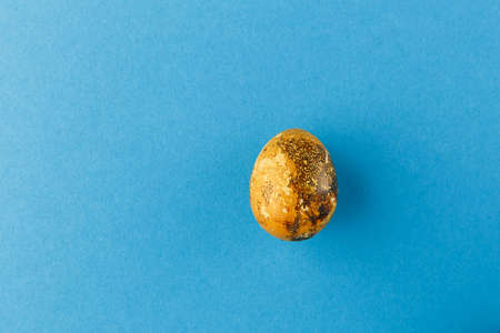 Easter egg painted orange with gold.の写真素材