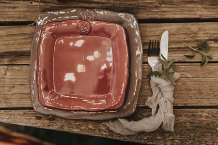 Beautiful table setting, square plates of different sizes lie on top of each other, minimalism, boho styleの写真素材