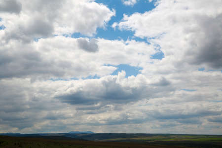 View to pasture meadows under a cloudy blue sky, landscape of remote places wild natureの写真素材