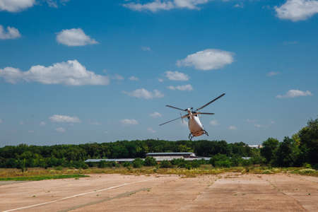 A white helicopter takes off from the runwayの写真素材