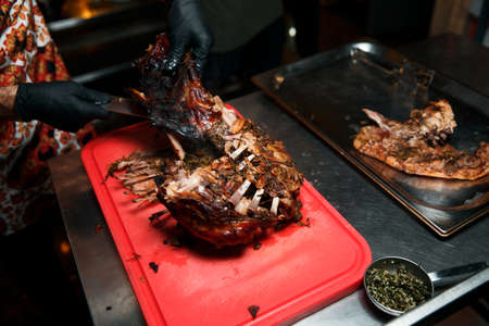 The cook cuts the cooked meat.の写真素材
