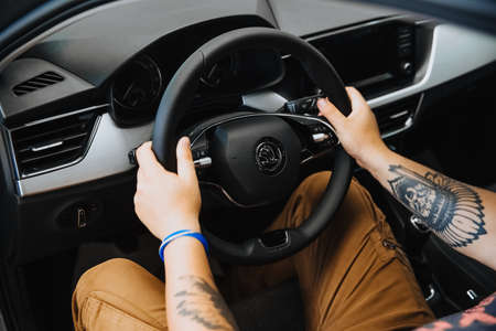 A mans hand holds the steering wheel of a car.のeditorial素材