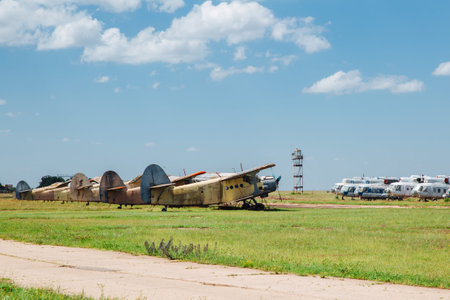 Old destroyed abandoned airplanes and helicopters in the field, cemetery of old helicopters and...
