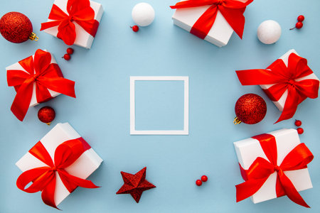 Christmas composition, gifts, fir tree branches, red decorations on blue background, winter, new...