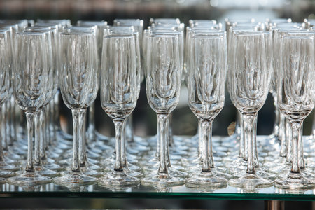 Empty glass transparent wine glasses on a table, catering background concept