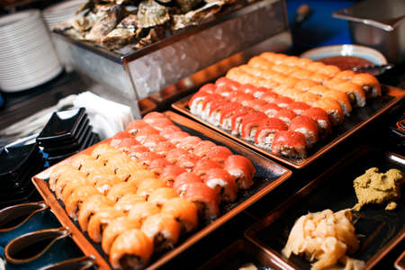 Traditional delicious fresh sushi roll set . Sushi roll with rice, cream chees, red fish, salmonの写真素材