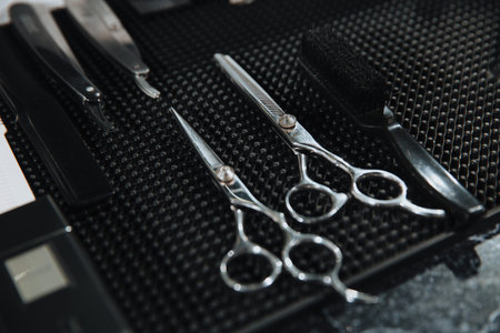 Professional scissors on black background. Hairdressing industry. Professional hairdressing tools