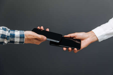 Horishni Plavni, Ukraine - 07, Juny 2022 : Tap to pay. iPhone is used as a payment terminal.のeditorial素材