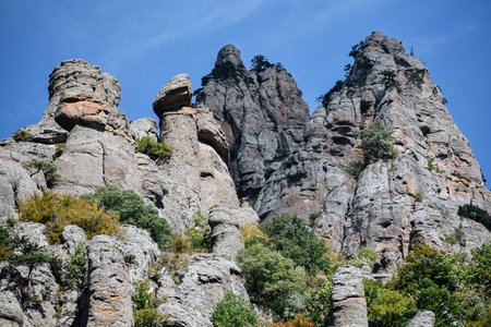 Stone hills and mountains against a blue sky .の写真素材