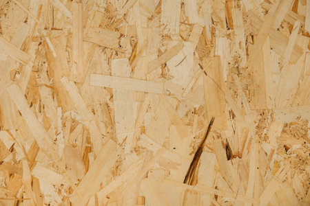 Close up pressed wooden panel background, texture of oriented strand board - OSB woodの写真素材