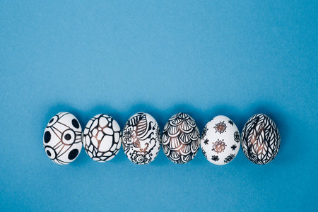 Easter eggs are painted black and white, abstraction, laid out in a row.の写真素材