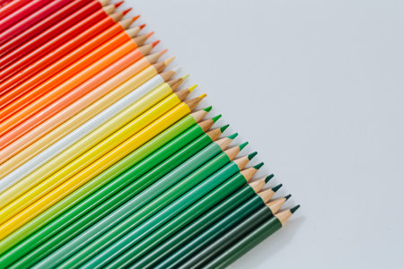Colored multicolored wooden pencils on a white backgroundの写真素材