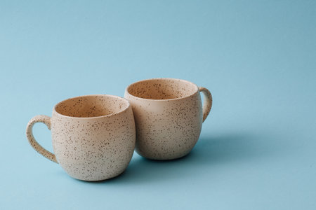Two porcelain empty cups on a blue background, copy space.の写真素材