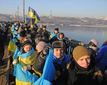 Participants of the action `Unite the banks of the Dnieper` a living chain of` Unity` on the Paton Bridge in Kiev, January 22, 2019.のeditorial素材