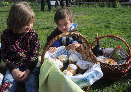 Children near Easter baskets at the Pirogovo National Museum of Folk Architecture and Life of Ukraine, in Kiev, April 28, 2019.のeditorial素材