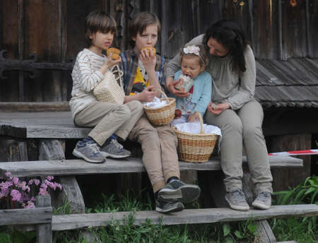 Children eat Easter cakes during Easter celebrations at the Pirogovo National Museum of Folk Architecture and Life of Ukraine, in Kiev, April 28, 2019.のeditorial素材