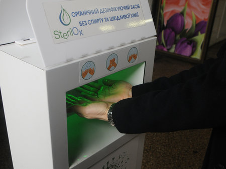 A woman disinfects her hands in one of the markets in Kiev, May 26, 2020.のeditorial素材