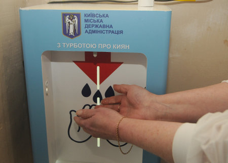 A woman disinfects her hands at the Center for Emergency Medicine and Disaster Medicine, in Kiev, May 26, 2020.のeditorial素材