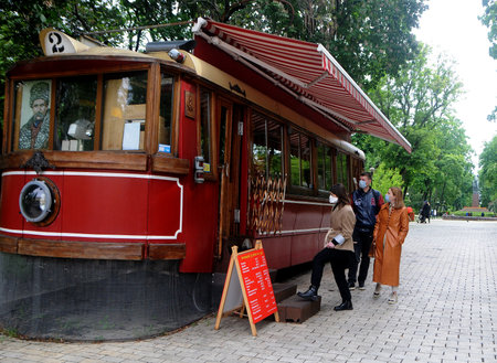 People in medical masks buy coffee during quarantine in Shevchenko Park, in Kiev, May 26, 2020.のeditorial素材