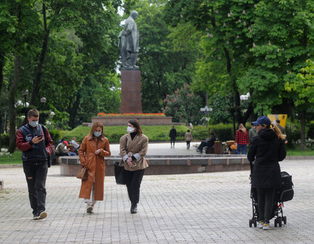 People in medical masks walk during quarantine in Shevchenko Park, in Kiev, May 26, 2020.のeditorial素材