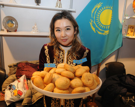 Girl with baursaks at the 26th Kiev International Women's Club Charity Fair on December 8, 2018のeditorial素材