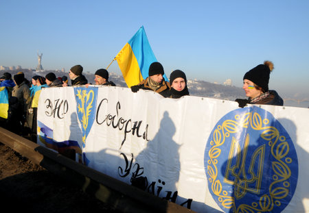 Participants of the action `Unite the banks of the Dnieper` a living chain of` Unity` on the Paton Bridge in Kiev, January 22, 2019.のeditorial素材