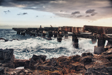 old bridge rack on an ocean lava beach in Hawaii during sunset