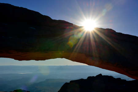 sun rays through the Mesa Arch in Canyonlands National Park, Utah in winterの写真素材