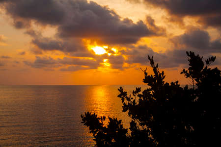 tropical sunset, clouds and the oceanの写真素材
