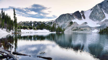 Snowy Range Mountains and lake in Medicine Bow, Wyoming during sunset in summerの写真素材